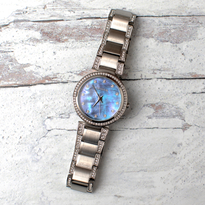 CITIZEN<sup>&reg;</sup>- Ladies Crystal Eco-Drive Watch. 
Silver-tone with Blue Mother of Pearl dial and crystal markers. The Stainless Steel bracelet and bezel are also accented with crystals for added brilliance. Eco-Drive allows it to charge by any light source indoors or out and will never need a battery. Water resistant to 50M. 
