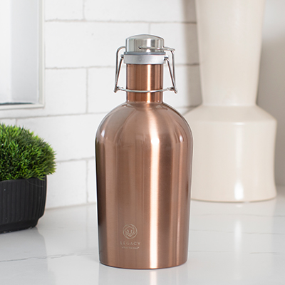 LEGACY<sup>&reg;</sup> Stainless Steel 64oz Growler - This insulated growler is great for picnics, BBQ’s, or for BYOB gatherings. Features include a copper finish and a secure swing top stopper with a silicone seal for leak prevention. Measures 4.5&quot; diameter by 11&quot; high.